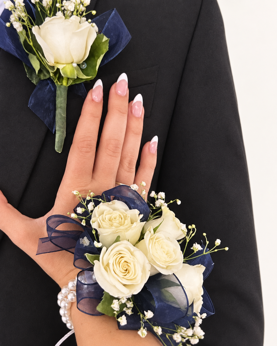 Arreglo floral 13: boutonniere y corsage de rosas blancas con listón azul marino