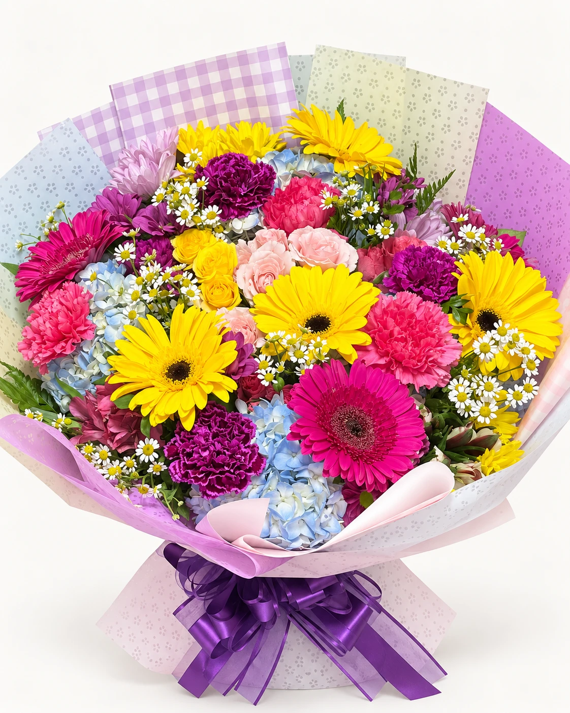 Ramo multicolor con gerberas amarillas y fucsias, claveles, hortensias azules y flores blancas, con envoltura rosa y lila y moño morado